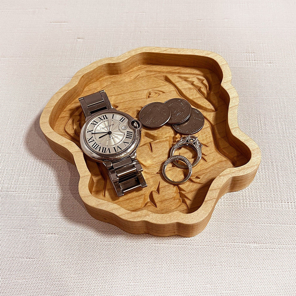 A Labrador wood tray with a watch and a pair of cufflinks.