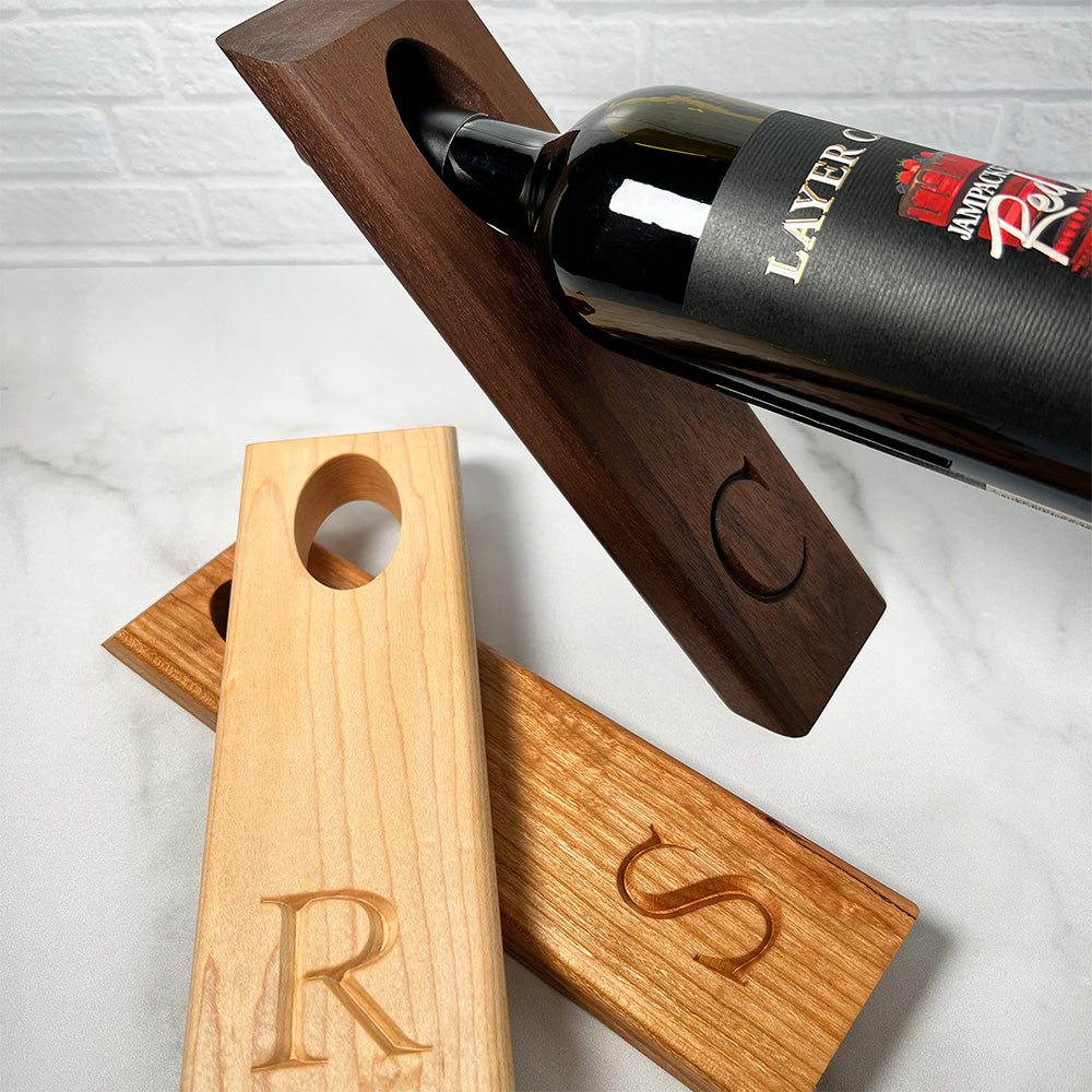 A wooden wine rack with a Balancing wine bottle holder on it.