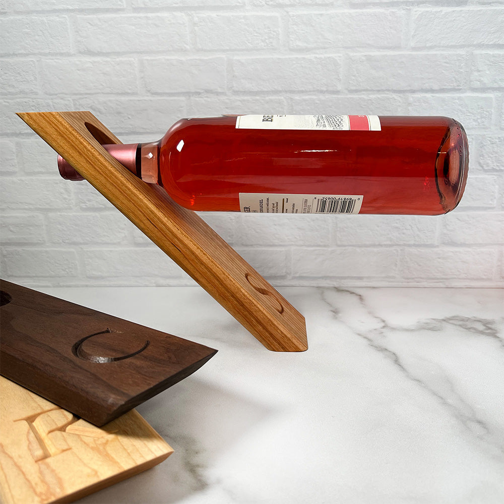A Balancing wine bottle holder with a bottle of wine.