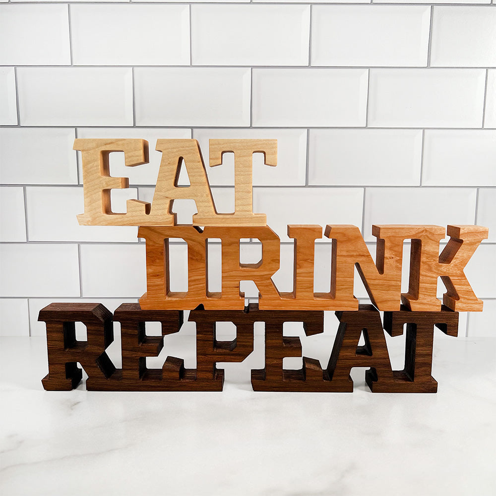 Standing words - Eat Drink Repeat wooden sign.