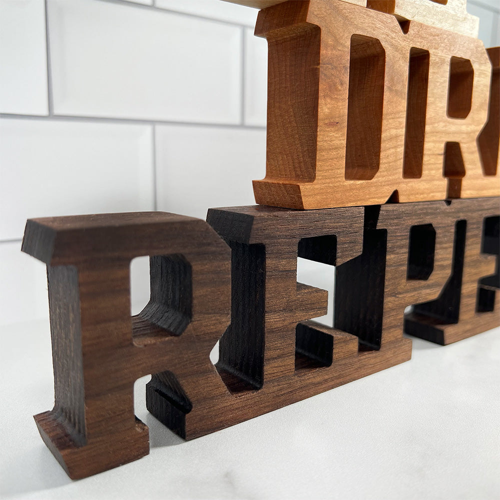 A wooden sign with the words 'Eat Drink Repeat' on it.