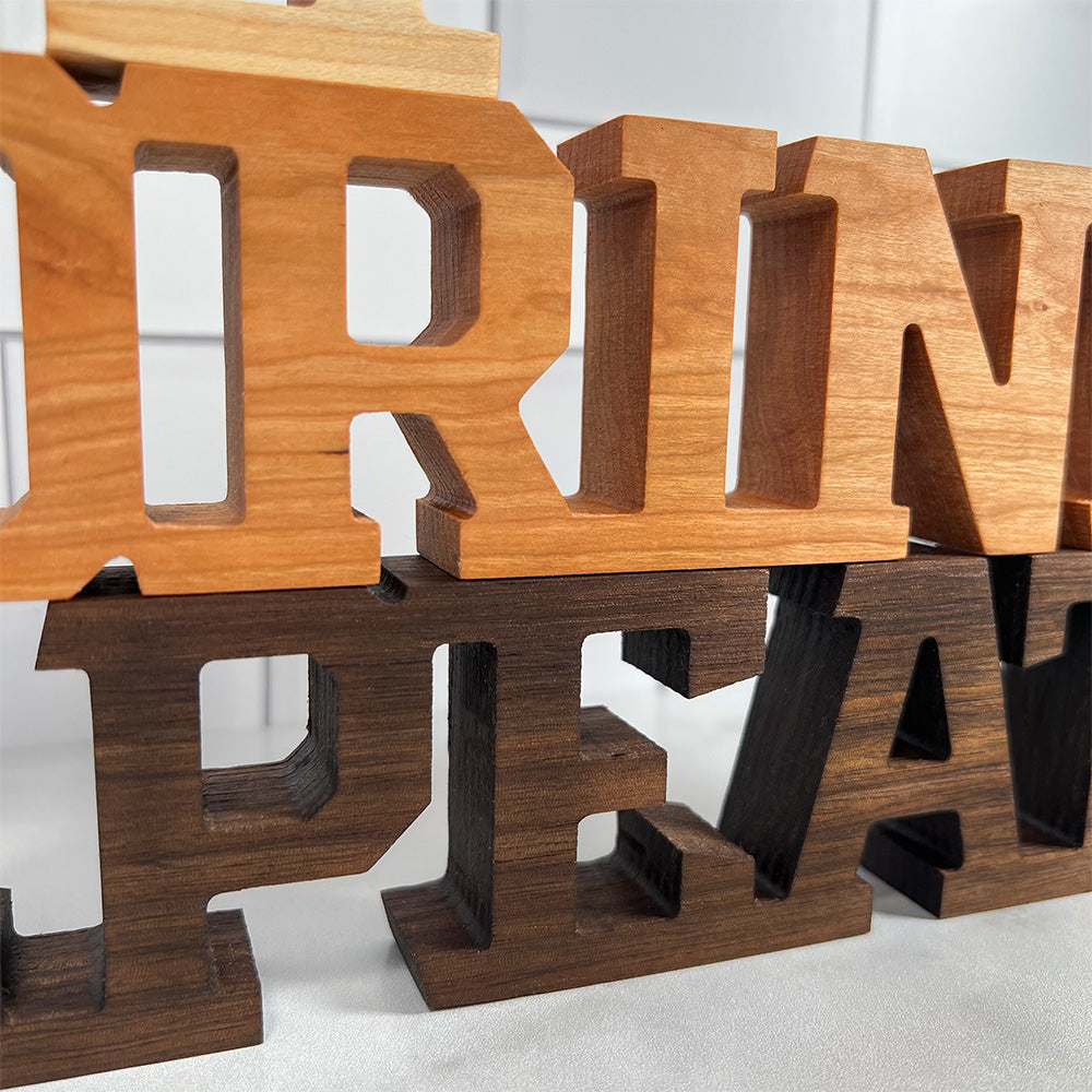 A set of wooden letters that say "Standing words - Eat Drink Repeat.