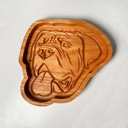 An English Mastiff wood tray with a dog's head on it.