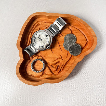 An English Mastiff wood tray with a watch and coins on it.