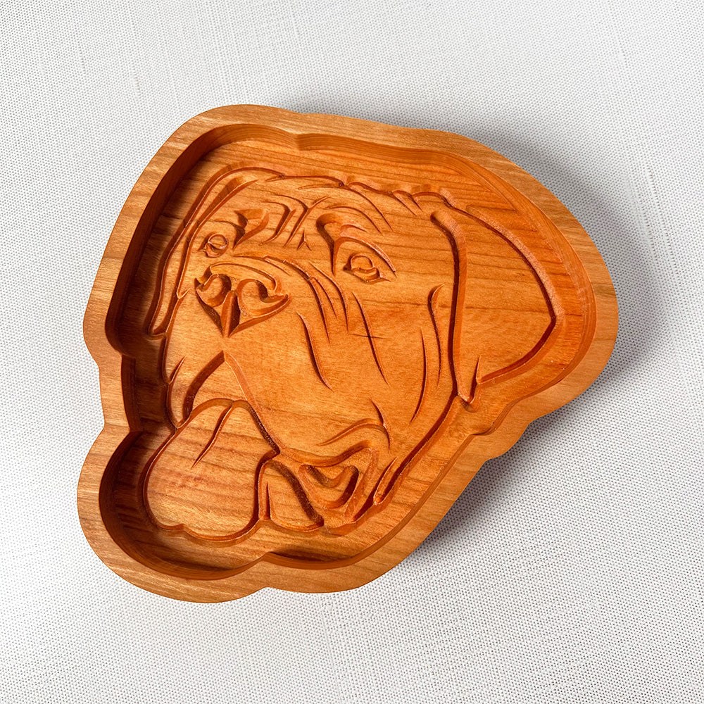 An English Mastiff wood tray with a dog's head on it.