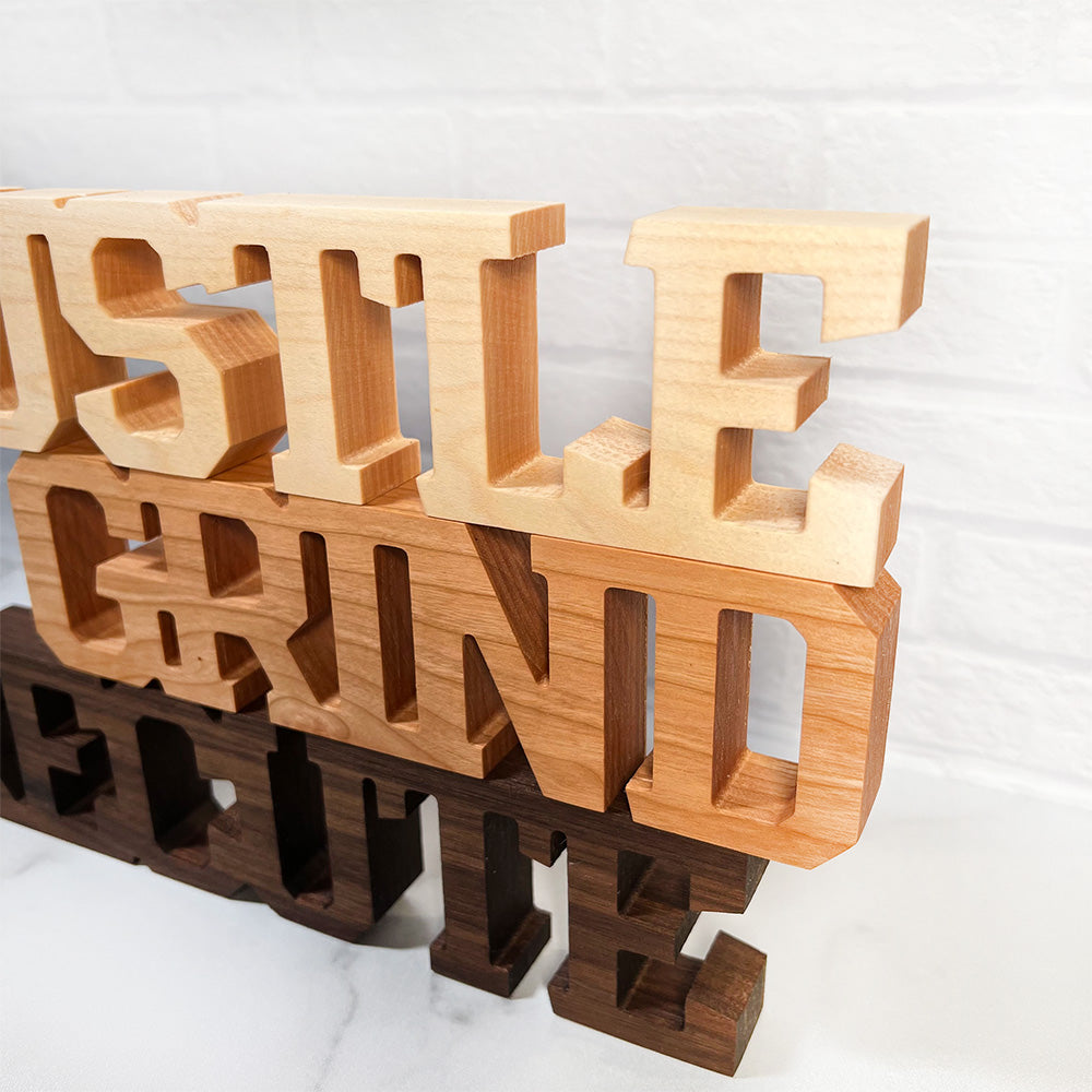 A set of Standing words - Hustle Grind Execute.