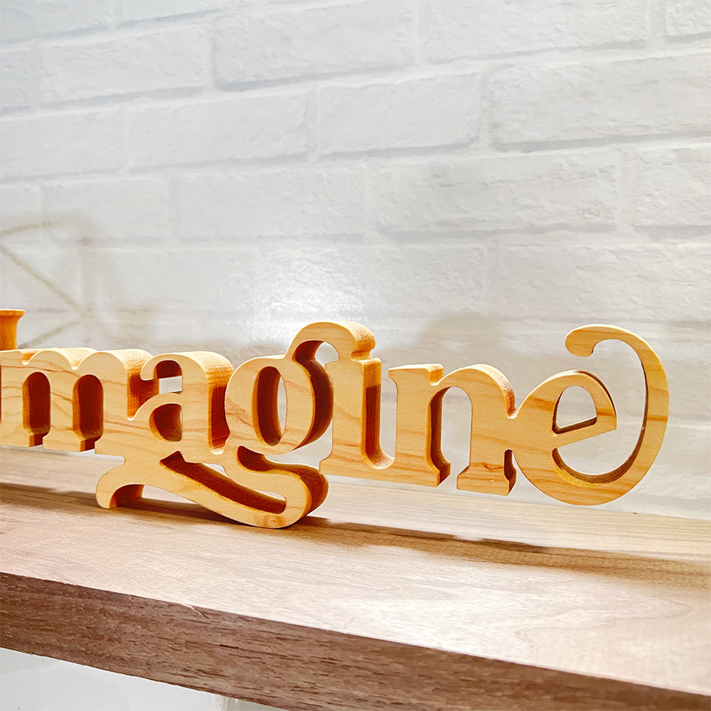 A Standing word - IMAGINE with the word imagine on it.