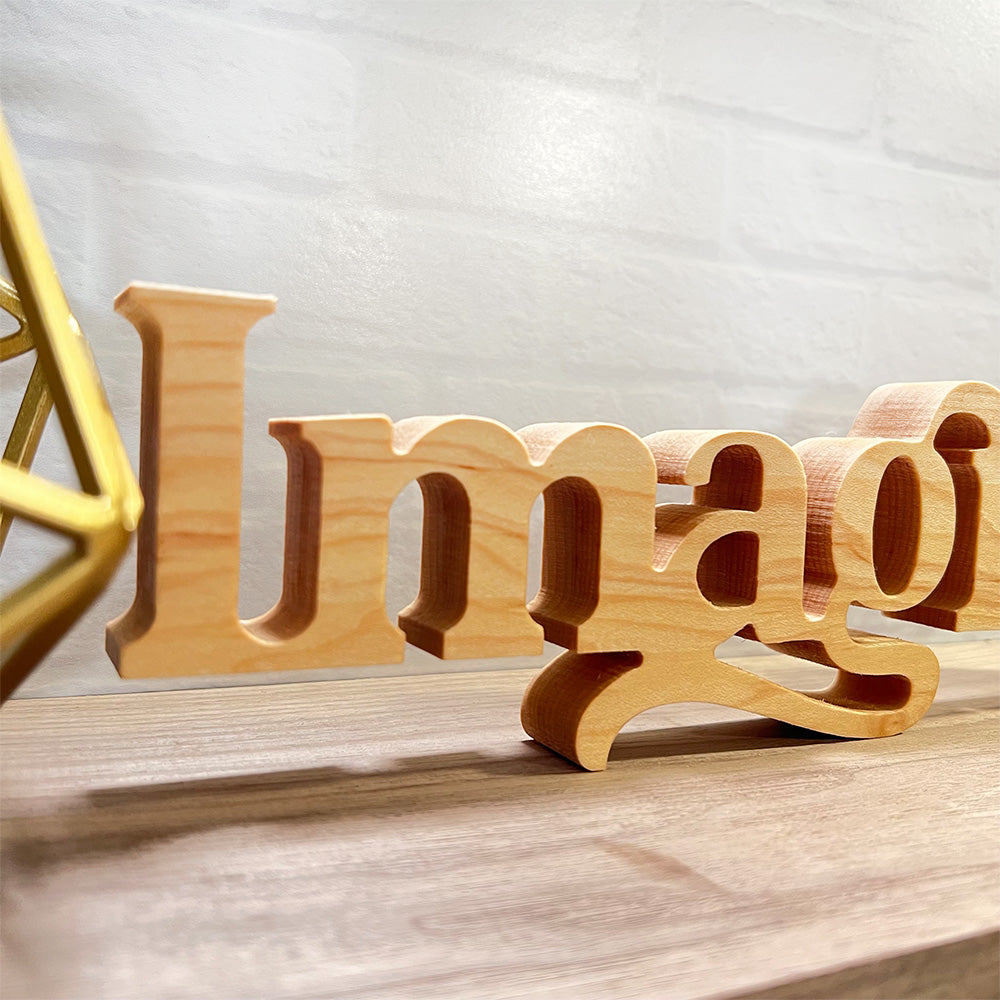 A wooden sign with the Standing word - IMAGINE on it.