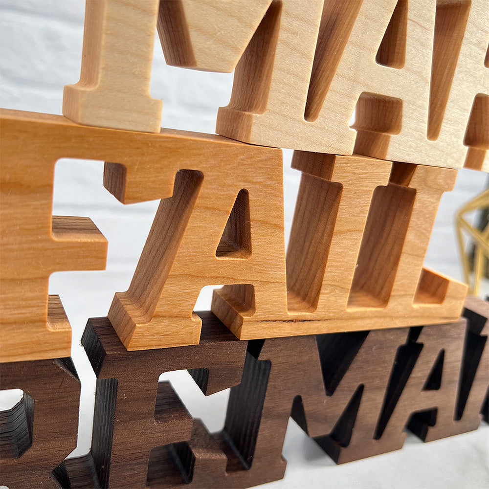 A set of wooden letters that say Standing words - Make Fail Remake.