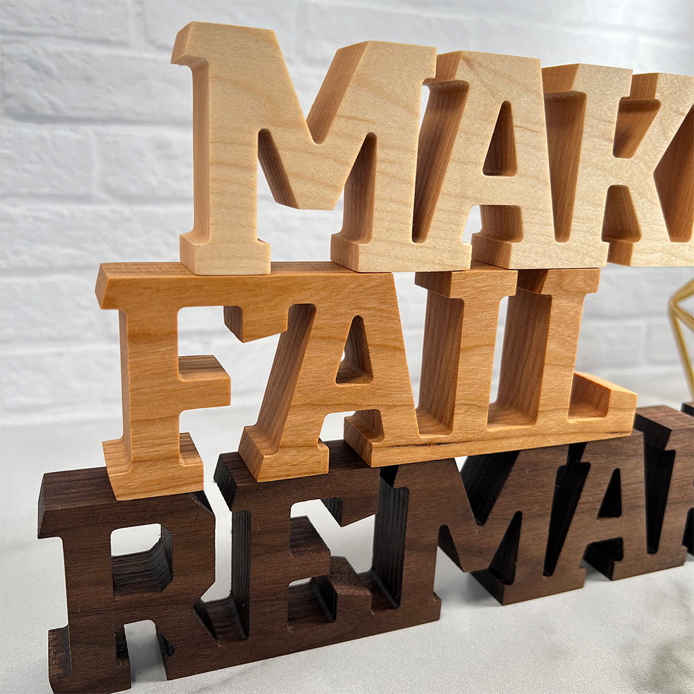 A wooden sign that says Standing words - Make Fail Remake.