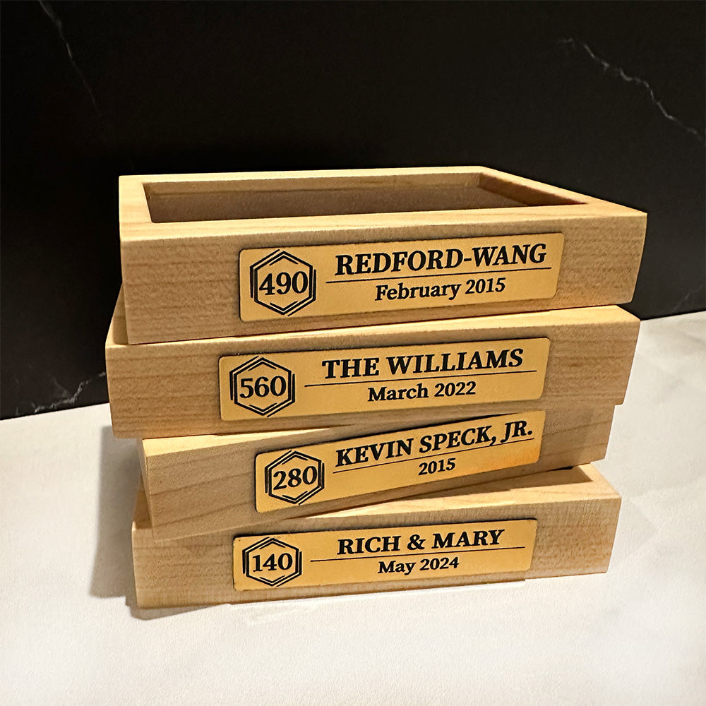 A stack of Cruise Milestone crystal block base boxes with names on them.