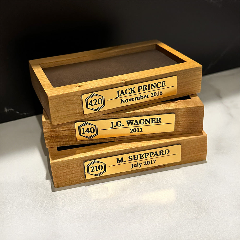 Three Cruise Milestone crystal block base with engraved plaques on them.