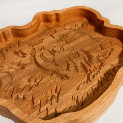 A Pomeranian wood tray with a carving of a tiger.