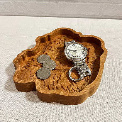 A Pomeranian wood tray with a watch and coins on it.