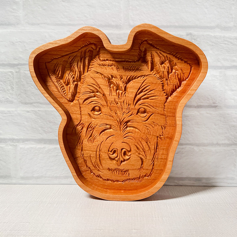 A Schnauzer wood tray with a dog's face on it.
