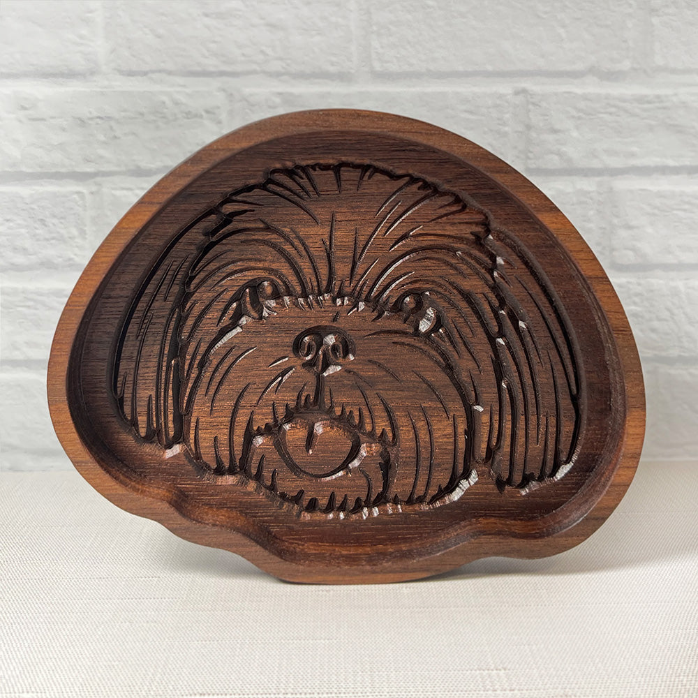 A Shih Tzu wood tray is carved into a wooden tray.