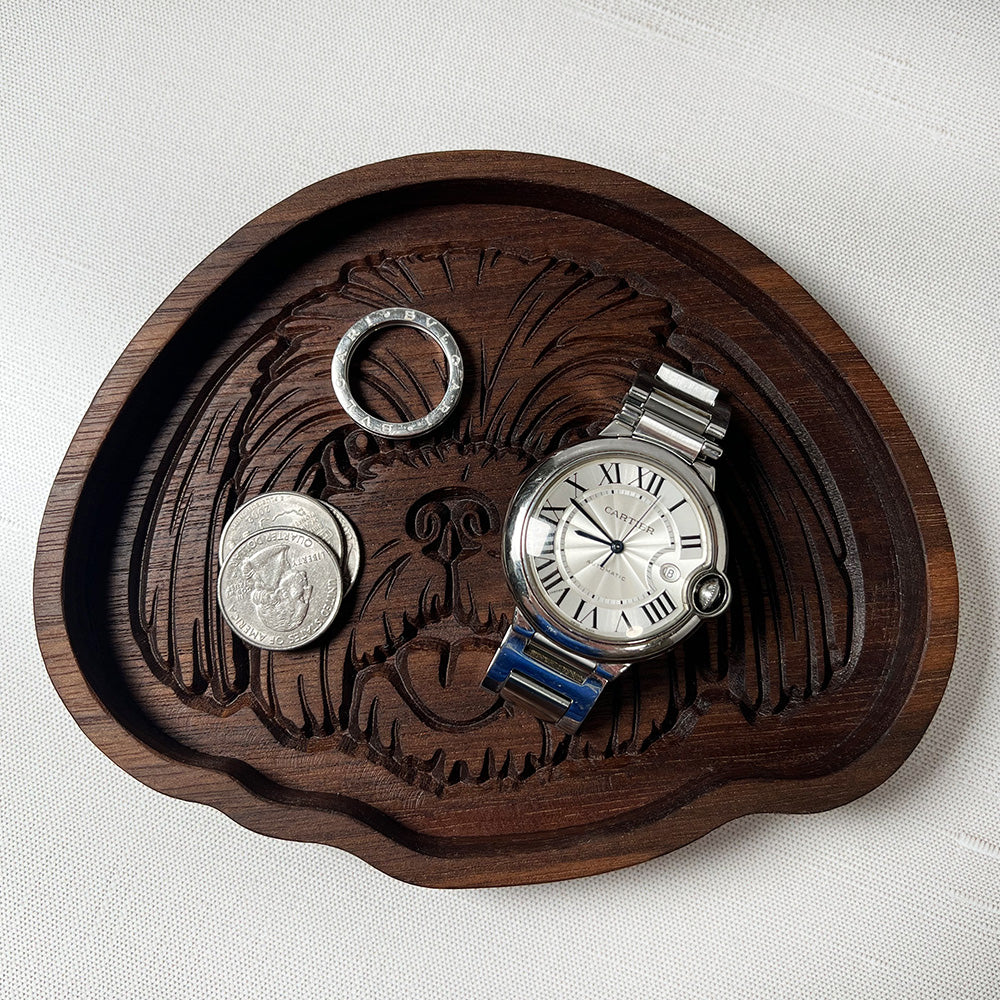 A Shih Tzu wood tray with a watch.