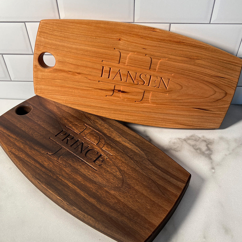 Two wooden cheese boards with the name hansen on them.