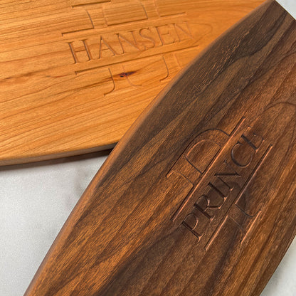 Two cheese boards with the name hansen on them.