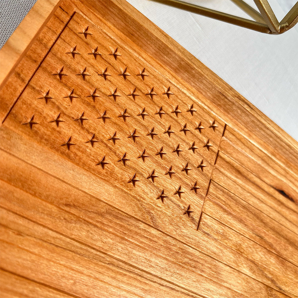 A USA Flag wood tray with a cross design on it.
